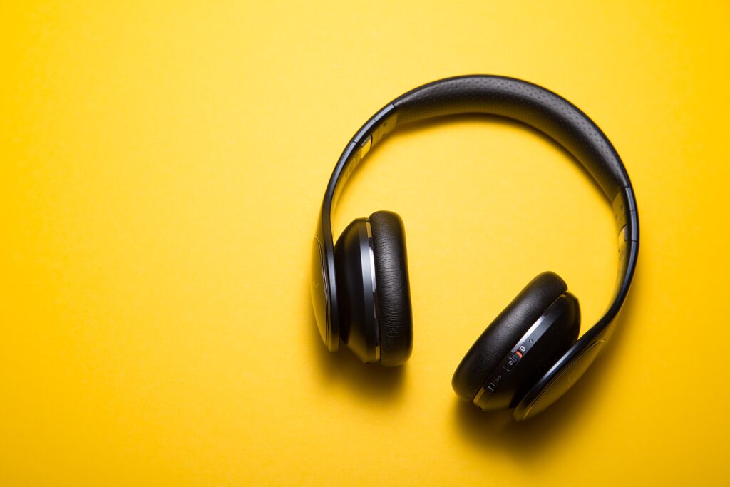 Black headphones on a yellow desk.